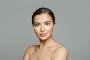 Güzel cildi ve beyaz arka planda sevimli gülüşü olan muhteşem, sağlıklı model bir kadın, stüdyo resmi. Yüz bakımı, cilt bakımı ve kozmetik konsepti