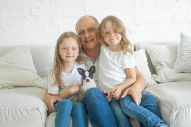 Neşeli bir ailenin portresi. Baba ve kızları içeride.