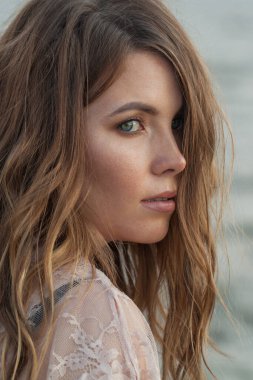 30 'lu yaşlarda açık havada dinlenen esmer bir kadının portresi.