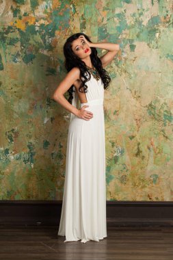 Muhteşem genç bayan model esmer. Kapalı alanda kameraya bakıyor. Tam boy portre.