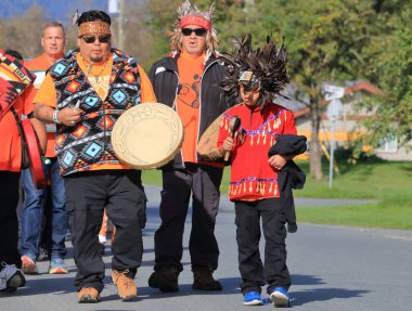 A young boy is seen leading the Skwah band during the Truth and Reconciliation ceremony march on September 30, 2024. The Skwah First Nation is a band of the Sto:lo people in Chilliwack, BC, Canada. clipart