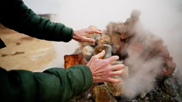 Close Shot Showing Hands Warming Fumarole — Stock Video