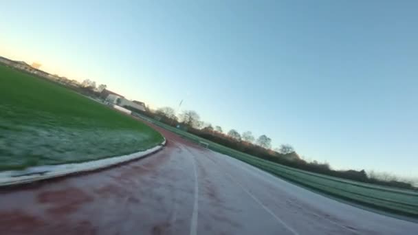 Drone Flying Low Quickly Hurdles Sunset Icy Running Track — Stock Video