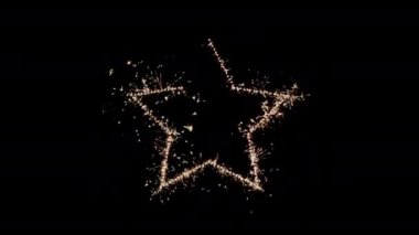 Sparklers burning brightly and forming into a five-pointed star on a dark background