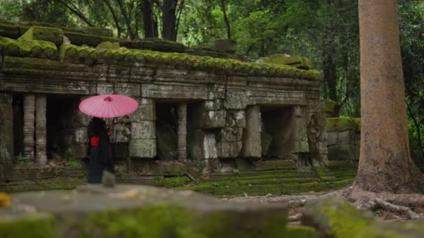 Wide Shot Woman Wearing Kimono Walking Mossy Temple Ruins Passing — Video