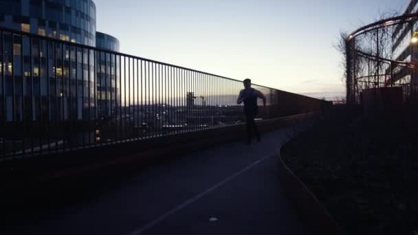 Full Shot Medium Shot Man Running Rooftop Railing Sunset — Stockvideo