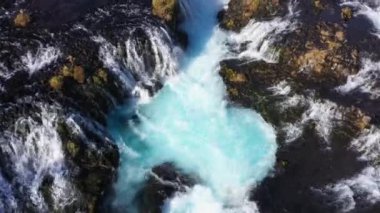 Drone footage of Bruarfoss waterfall showing the countless streams flowing down the blue river