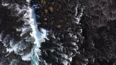 Aerial view of several streams flowing down a blue river