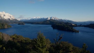 A panning shot moving from left to right, showing a panoramic view of the Lake District at Bariloche, Argentina during daytime