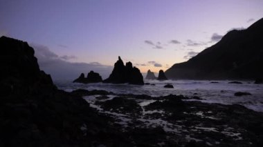 Twilight sky over the rocky seashore and sea stacks at the Benijo beach in Tenerife, Spain