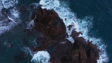 Drone over the blue sea waves and sea stacks at Benijo beach in Tenerife, Spain during daytime