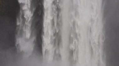 A still shot showcasing the waters falling on the Skogafoss waterfall located in Iceland