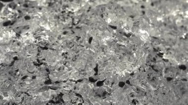 Close-up of the glistening surface of an iceberg that drifted ashore on Diamond Beach