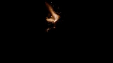 Slow motion lighting of a sparkler in the dark