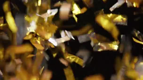 Nahaufnahme Von Gold Und Silberkonfetti Das Auf Einen Dunklen Hintergrund — Stockvideo