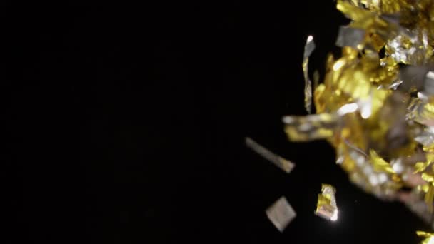 Shiny Silver Gold Confetti Blown Side Black Background — Stockvideo