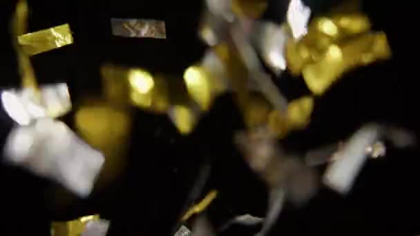 Close Shiny Gold Silver Confetti Falling Black Background — Wideo stockowe