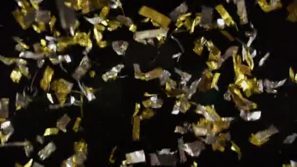 Brilhantes Confetes Caem Contra Fundo Escuro Com Efeito Brilho Lente — Vídeo de Stock