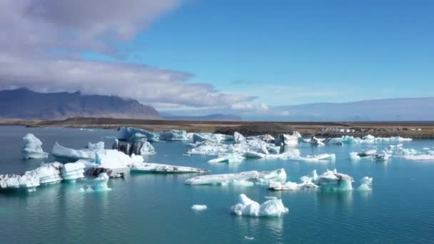 昼間にアイスランドのジョクルサロン氷河ラグーンで氷山の上にドローンが撃たれました — ストック動画
