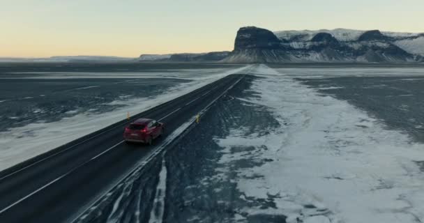 Aerial Shot Red Car Venturing Road Snowy Lomagnupur Mountain Iceland — Αρχείο Βίντεο