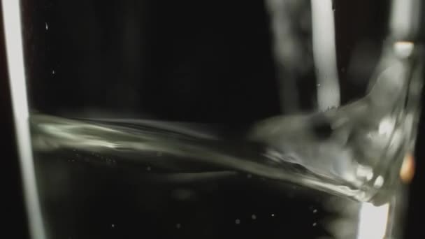 Detailní Záběr Nalití Šampaňského Již Naplněné Sklenice Vína Tmavém Pozadí — Stock video
