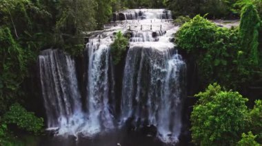 Kamboçya 'nın çevresini çevreleyen yeşil manzaralı Phnom Kulen' in doğal şelalesinin gündüz hava görüntüsü