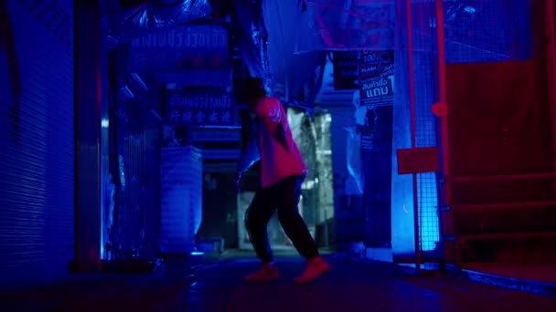 バンコクの青い路地でスローモーションでパフォーマンスするストリートダンサーの全身ショット — ストック動画