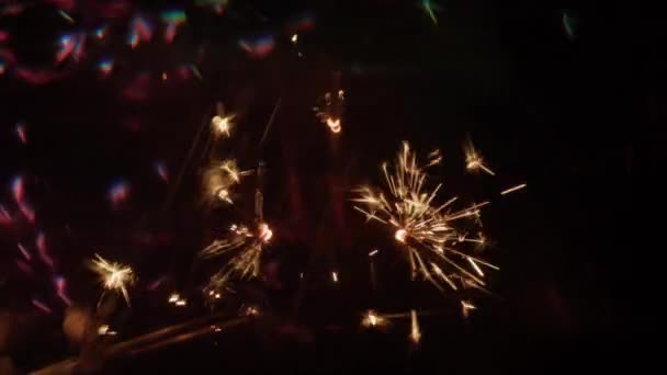 Brennende Wunderkerzen Dreieckiger Position Erzeugen Verschwommene Grüne Rosa Und Goldene — Stockvideo