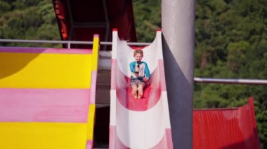 Tayland 'da bir su parkında kayan kameralı bir çocuğun videosu.