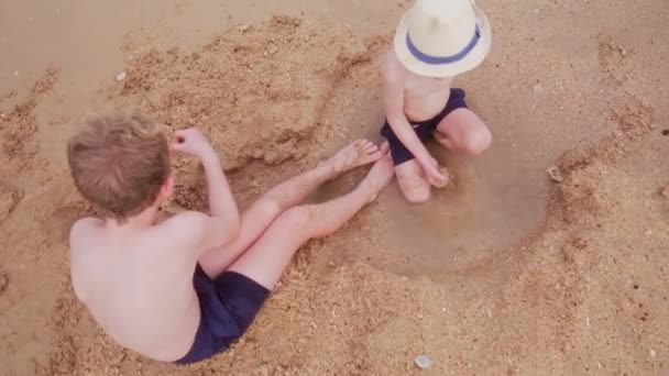 Top View Shot Showing Two Boys Sitting Wet Sand Beach — Stock Video