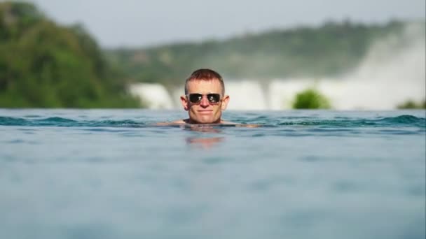 Man Sunglasses Slowly Approaches Camera While Swimming Pool Iguazu Falls — Stock Video