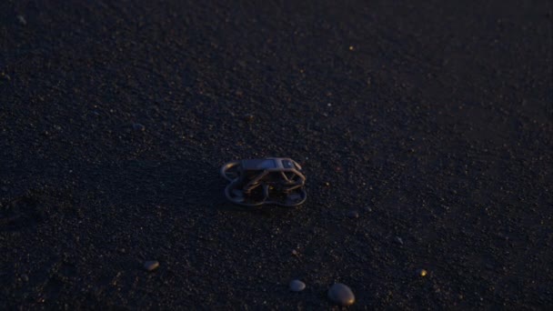 Fpvドローンはレイニスフィハラビーチの黒い砂の上にそのプロペラを回転させます — ストック動画