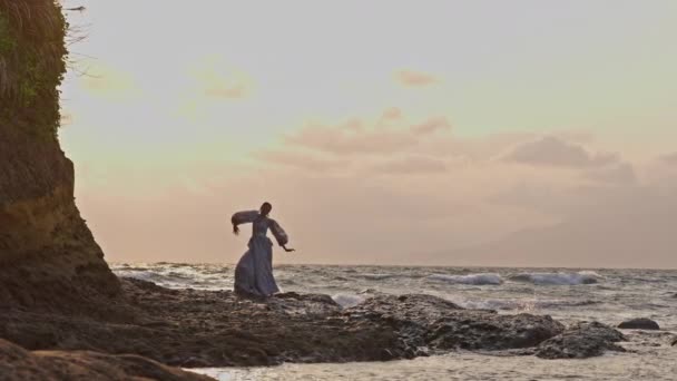 Kobieta Sukience Tańcząca Wdziękiem Skalistym Brzegu Przed Falami Rozbryzgu — Wideo stockowe