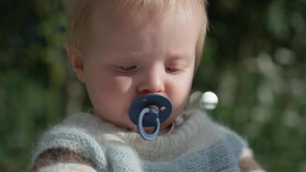 Detailed View Infant Gently Nibbling Pacifier — Stock Video