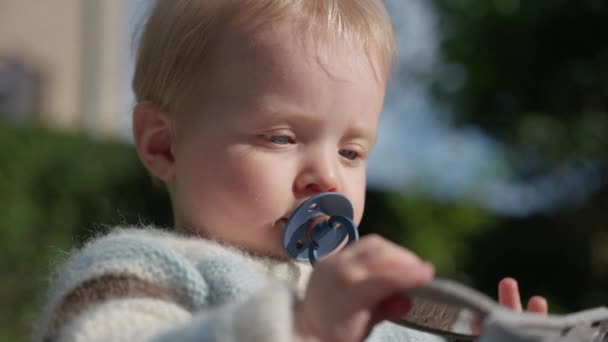 Detailed View Baby Gently Nibbling Pacifier — Stock Video