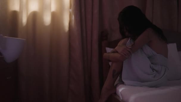 Sentada Beira Cama Uma Mulher Abraça Joelhos Com Toque Terno — Vídeo de Stock