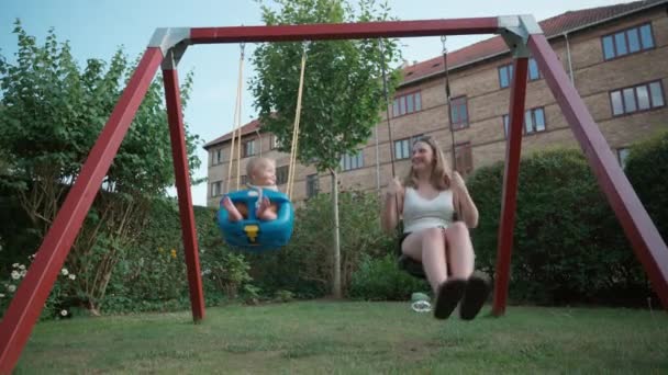 Mother Her Son Savoring Delightful Swing Ride Together — Stock Video