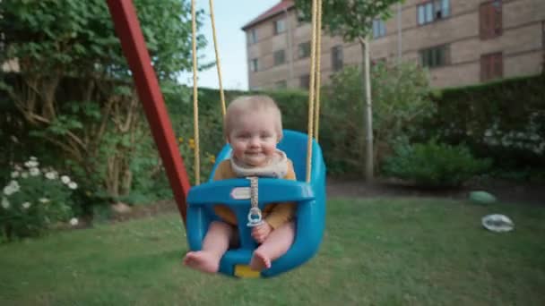 Lovable Young Child Happily Swinging Alongside Her Mother — Stock Video