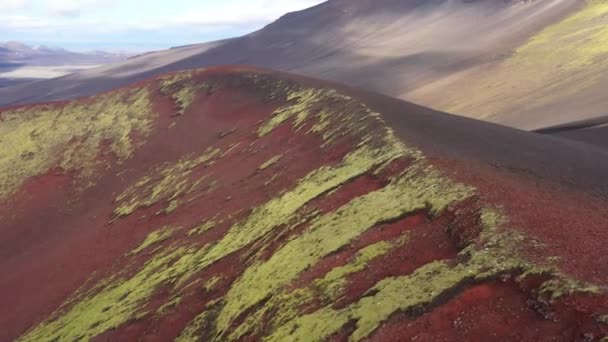 ドローンは上昇する前にラウダスカルクレーターの端に近づいて飛び 昼間のハイラス火山の近くの広大で暗い風景を明らかにします — ストック動画