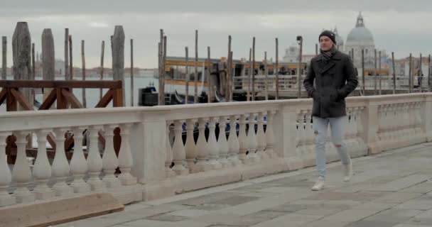Man Wearing Black Beanie Jacket Leisurely Walking White Marble Balustrades — Stock Video