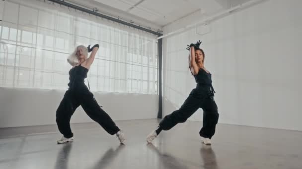 Static Full Perspective Showcases Two Women Sleek Black Outfits Performing — Stock Video