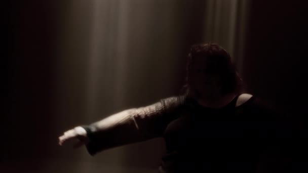 Dancer Black Attire Shines Warm Spotlights Captured Dynamic Handheld Shot — Stock Video