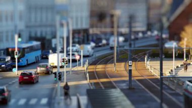 Arabalar, otobüsler, bisikletçiler ve tramvaylar caddelerde dart oynayarak bu büyüleyici minyatür dünyada büyüleyici bir hareket balesi yaratıyor.