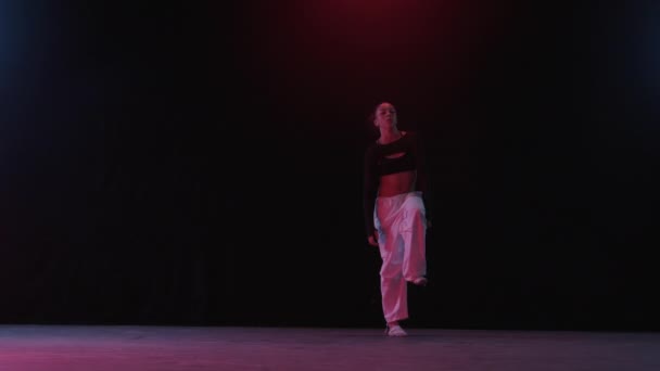 Dimly Lit Studio Young Woman Moves Captivating Grace Amidst Red — Video Stock