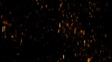 Sayısız küçük, parıldayan parçacıklar aşağı doğru siyah bir zemine düşerler. Parçacıklar öncelikli olarak turuncu ve sarıdır, kırmızı ve beyaz ipuçları ile sıcak ve ateşli bir görünüm oluştururlar.