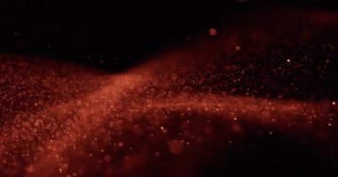 Büyüleyici kahverengi kum tanecikleri karanlıkta kıvrılır ve zarifçe dağılır, büyüleyici bir doku ve hareket dansı yaratır.