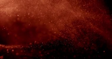 Büyüleyici kahverengi kum tanecikleri zarif bir şekilde karanlık bir arkaplanda akarak sakin ve zarif bir görsel deneyim yaratırlar.