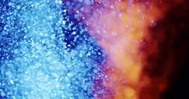 Renkli bir girdap görüntüsü, yüzen parçacıklar soldaki serin mavi tonlardan sağdaki sıcak turuncu ve kırmızı tonlara geçiş yapıyor..