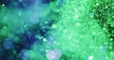 Göz kamaştırıcı, mor ve yeşil tonlarda canlı parçacıklardan oluşan bir dizi siyah arkaplan boyunca süzülüp yayıldıkça değişen bir etki yaratır..