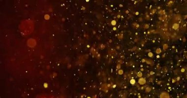 Parlayan altın parçacıkların dinamik bir sahnesi karanlık bir boşlukta süzülür ve yavaşça incelerek koyu kırmızı renge dönüşür.